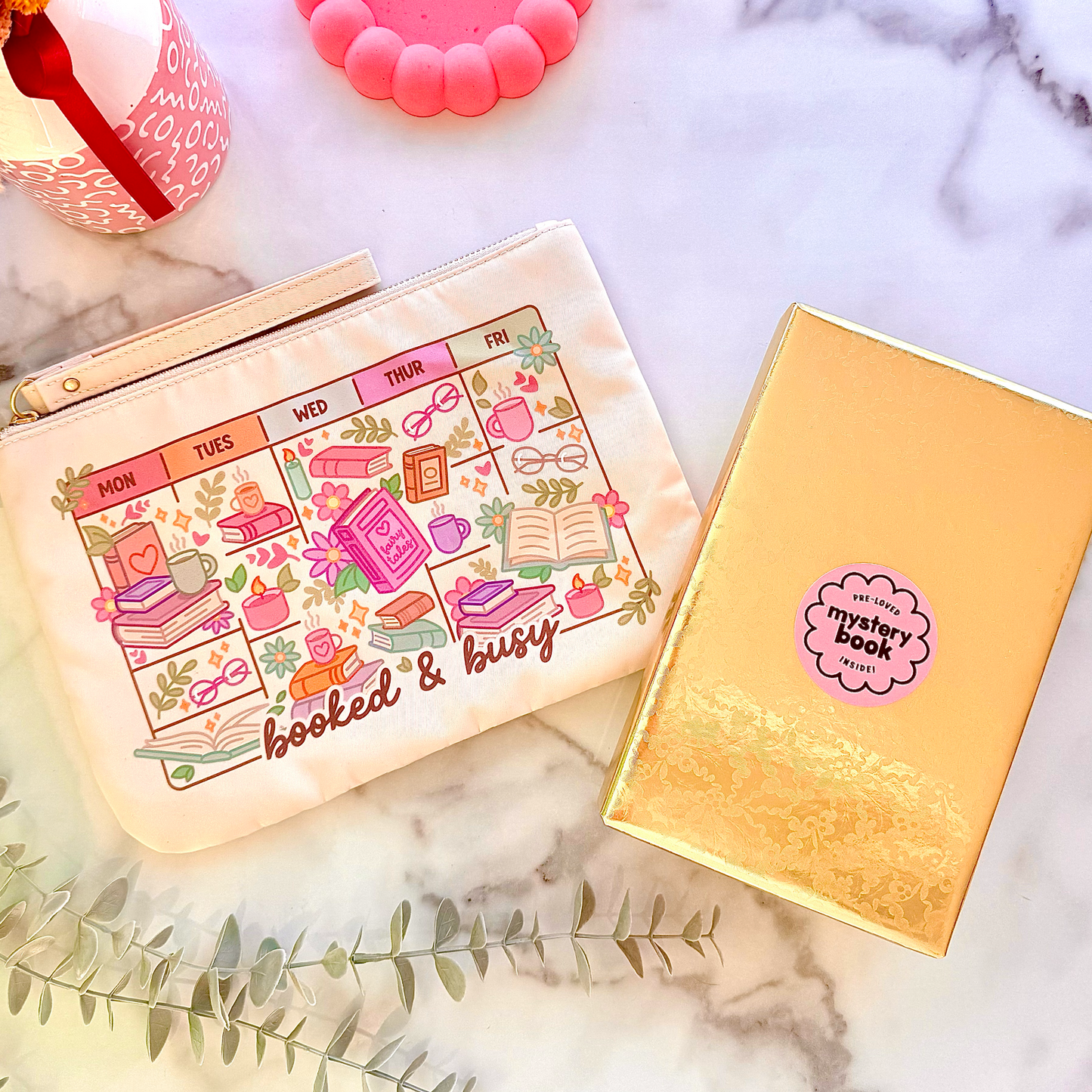 Pouch with calendar design and notebook on a marble surface