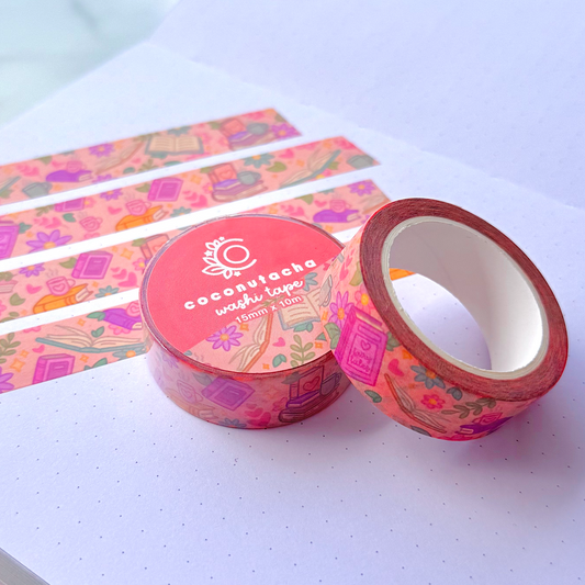 Decorative washi tape with a pink and orange design on a white surface.